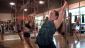 These participants learn to use the pole for limbering up